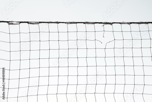 Torn volleyball net on sky background (failure, loss, breakdown - concept)
