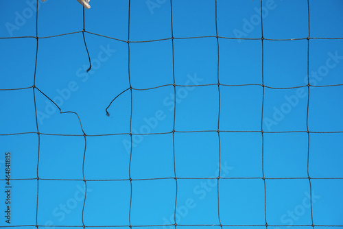 Obraz na płótnie Torn volleyball net on sky background (failure, loss, breakdown - concept) w salonie