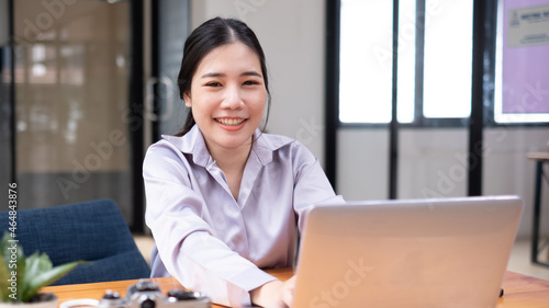 Young Woman using Laptop in the office. photo
