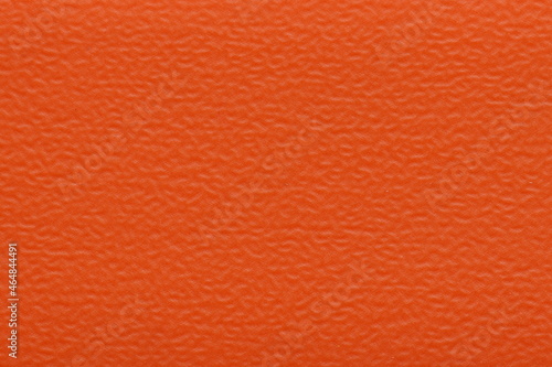 The texture of PVC plastic is orange for edging the ends of the chipboard. Decorative orange background texture. 