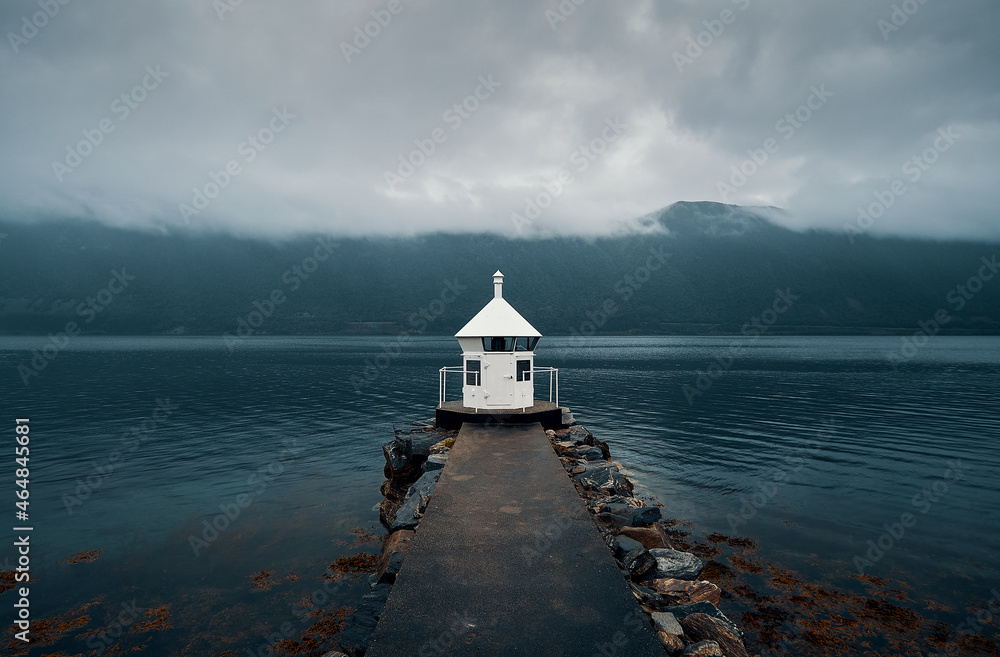 Lighthouse inside a fjord on a rainy day, Norway
