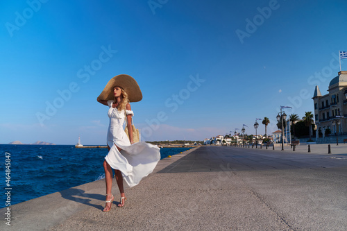 Beautiful girl tourist walking at Spetses marina seaport, Greece © Anatoly Repin