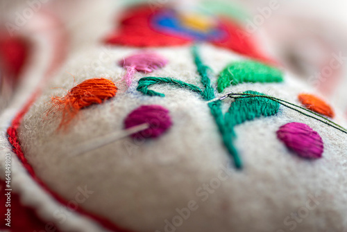 Konstfotografi decorative needlepoint with patterns made of felt and threaded sewing needle