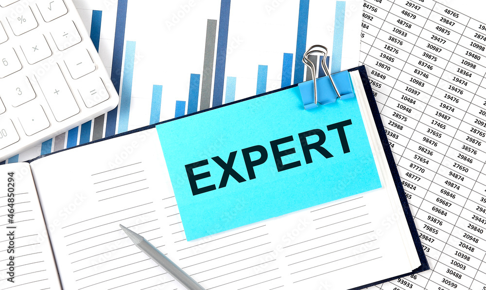 EXPERT text on blue sticker on the chart background near calculator EXPERT text on blue sticker on the chart background near calculator