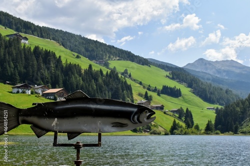 boat and decorations on the Valdurna lake in South Tyrol with clear sky and reflections photo