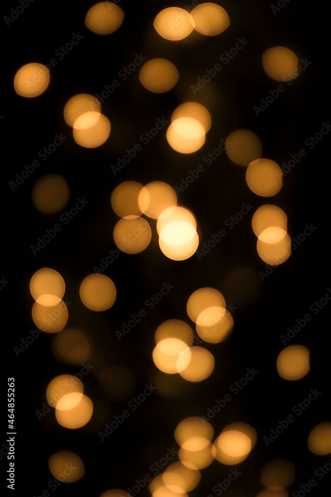 Obraz premium yellow defocused lights on a black background. Bokeh