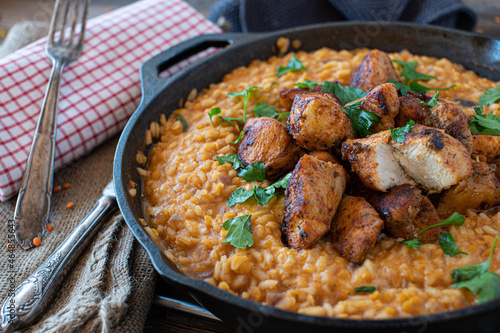 fried chicken breast with tomato, red lentil risotto