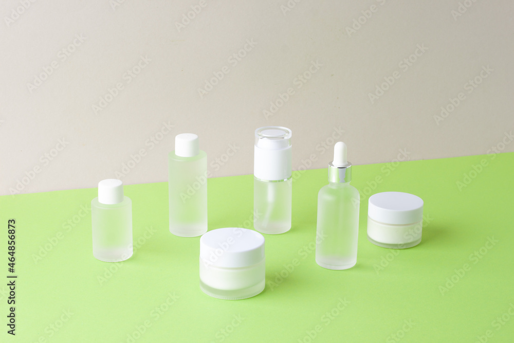 Cosmetic skin care products on green and grey background. Close up, copy space Cosmetic skin care products on green and grey background. Close up, copy space