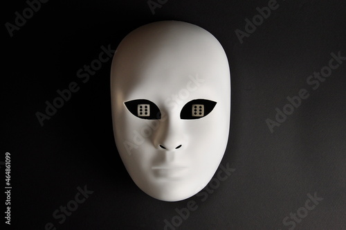 White theatrical mask and playing dice