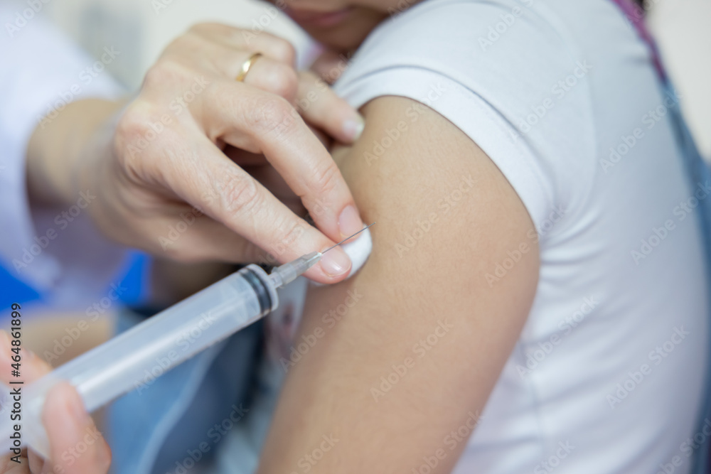 Doctor Holding Syringe Injecting the Vaccine into Patient Shoulder