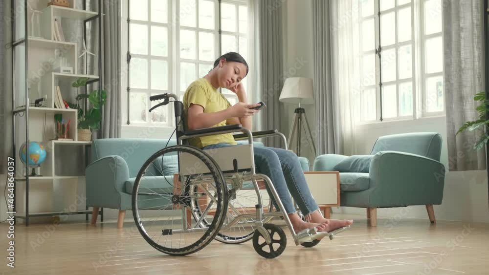 Bored Asian Kid Girl Sitting In A Wheelchair While Using Smart Phone At Home
Bored Asian Kid Girl Sitting In A Wheelchair While Using Smart Phone At Home