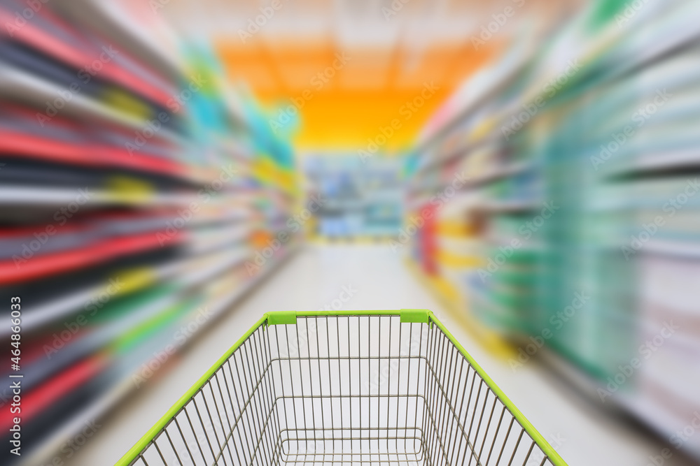 Shopping cart in blur supermarket background. Shopping cart in blur supermarket background.