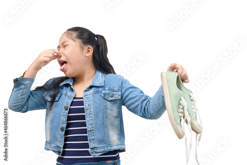 Young Asian girl feeling unhappy with bad smell sneaker shoes isolated