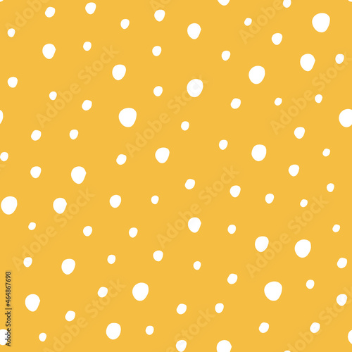 Seamless vector pattern with white polka dots on yellow background.