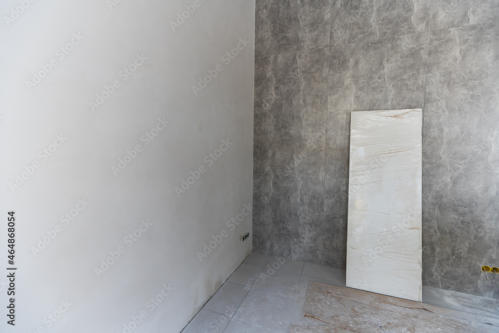 The wall of the building is covered with fresh plaster and surrounded by construction. Background. The wall of the building is covered with fresh plaster and surrounded by construction. Background.