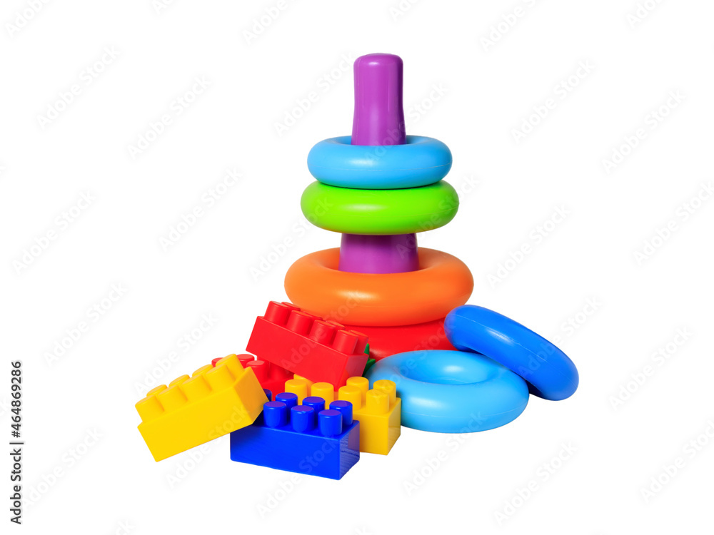 Plastic building blocks and pyramid with rings isolated on white background. The concept of children's educational toys for toddlers Plastic building blocks and pyramid with rings isolated on white background. The concept of children's educational toys for toddlers