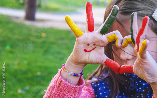 children hands in colors. Summer photo. Selective focus.