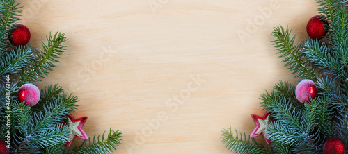 Christmas fir tree with decoration on a wooden board. Copy space. Selective focus. Banner