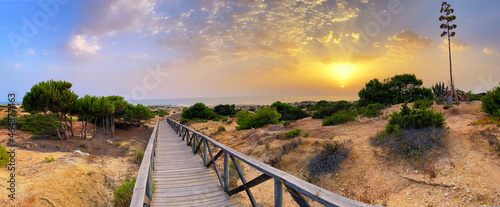 The gateway to La Barrosa beach at sunset in Cadiz, Spain photo