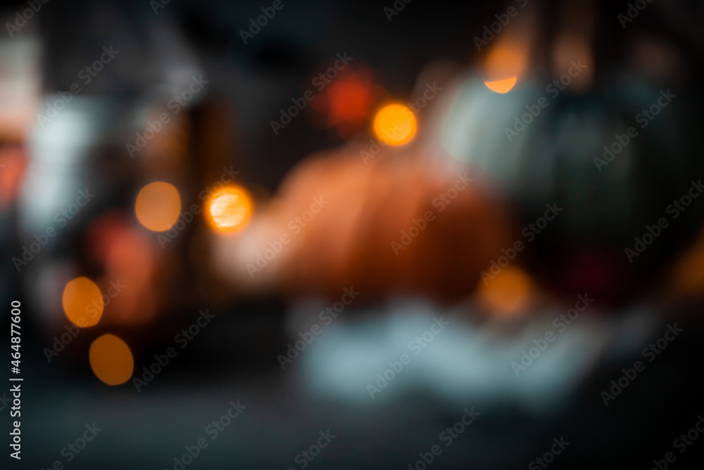 Blurred Halloween background with warm bokeh lights. Theme of fear on night of October the 31