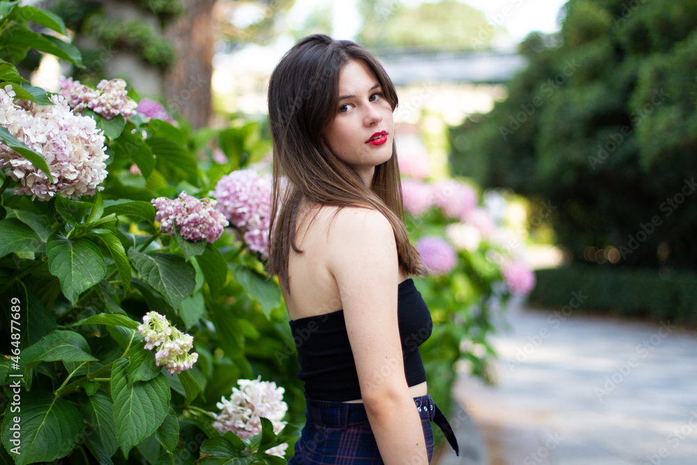 Young woman with stylish clothes posing in a paradisiacal park Young woman with stylish clothes posing in a paradisiacal park