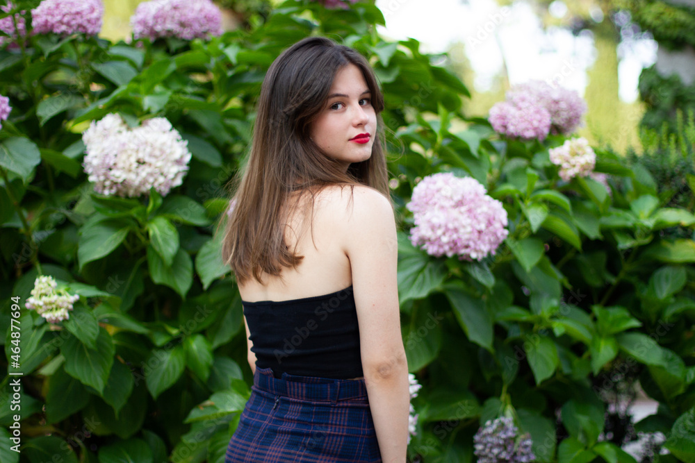 Young woman with stylish clothes posing in a paradisiacal park Young woman with stylish clothes posing in a paradisiacal park
