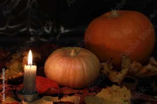 Orange pumpkins are a symbol of the holiday - All Saints Day. Subdued light. Evening by candlelight.