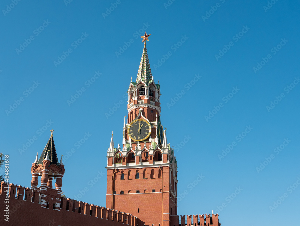 Red Square. Spasskaya clock tower and part of the Kremlin wall against the blue sky. Moscow, Russia. Red Square. Spasskaya clock tower and part of the Kremlin wall against the blue sky. Moscow, Russia.