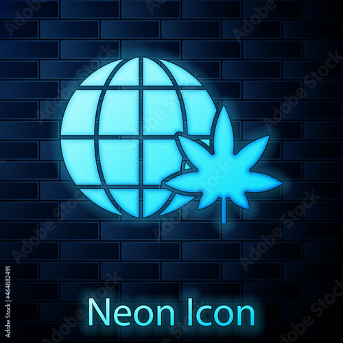 Glowing neon Legalize marijuana or cannabis globe symbol icon isolated on brick wall background. Hemp symbol. Vector Illustration