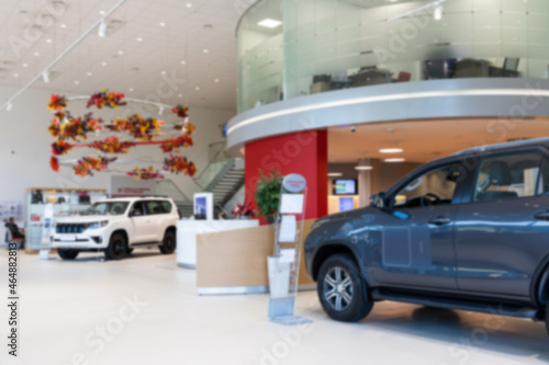 interior of a car dealership selling premium cars, photo with blur