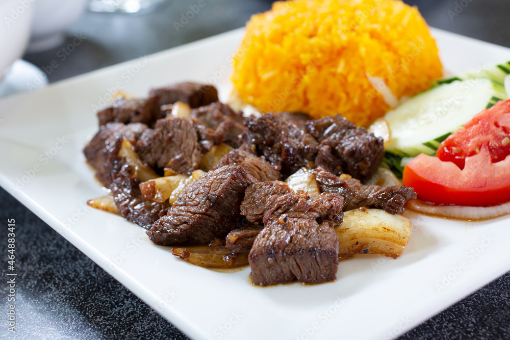 A view of a plate of shaking beef.