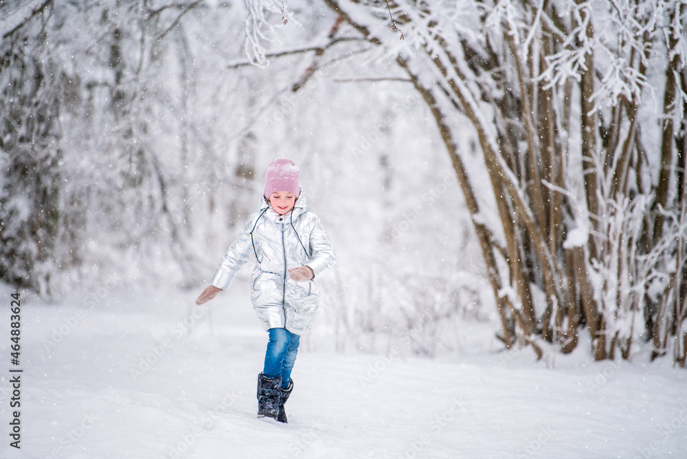 little girl child running in winter in snowy park little girl child running in winter in snowy park