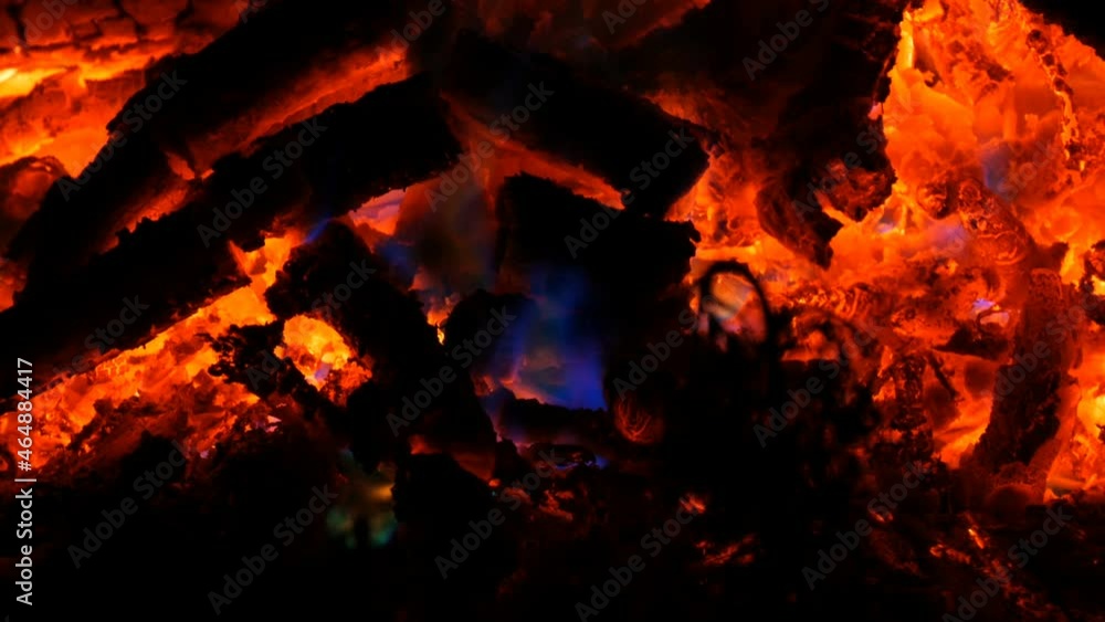 Rainbow mystical bonfire on burning wood in dark Rainbow mystical bonfire on burning wood in dark