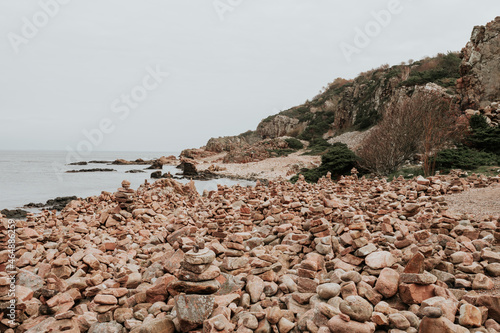 Balancing stones on the rocky coast at Hovs Hallar nature reserve in Sweden. photo