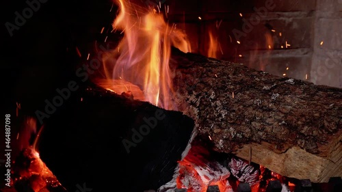 Burning fireplace, real wood logs, cozy warm home at xmas time photo