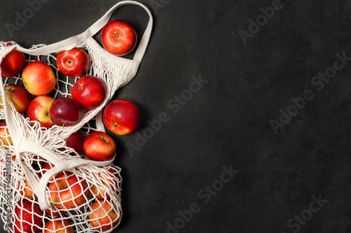 Apples starking in the mesh bag. Sustainability and conscious consuming concept. Top View. Flat Lay. Free space for text.