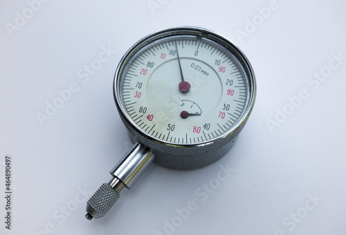 A metal curvimeter on a white isolate. A mechanical device with a scale and divisions. An accurate measuring device.