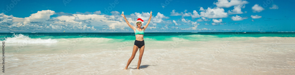 Young woman in santas hat relaxing tropical sand beach christmas sunny day Young woman in santas hat relaxing tropical sand beach christmas sunny day