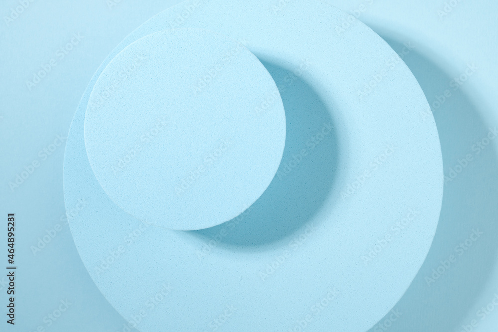 Two round blue catwalks on a blue background. View from above. Background for product display. Two round blue catwalks on a blue background. View from above. Background for product display.