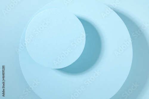 Two round blue catwalks on a blue background. View from above. Background for product display.