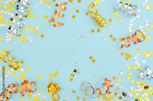 New Year, Christmas, or Birthday background. Scattered holiday confetti, streamers, stars and glitter.