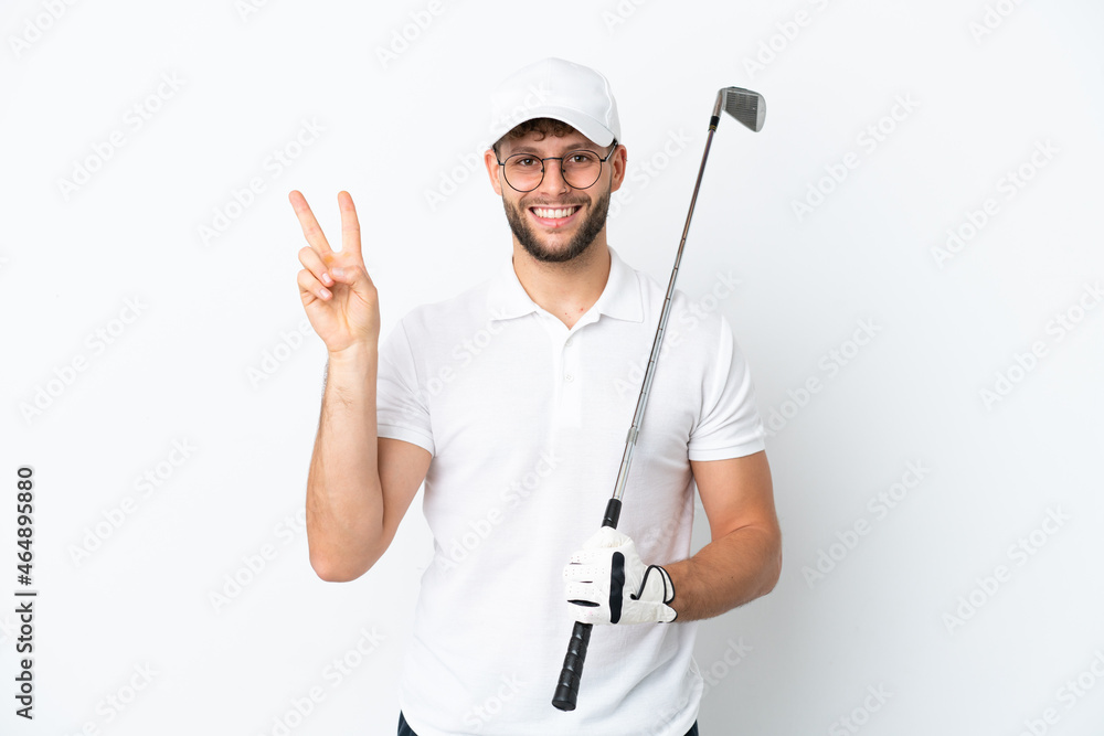 Handsome young man playing golf isolated on white background smiling and showing victory sign Handsome young man playing golf isolated on white background smiling and showing victory sign