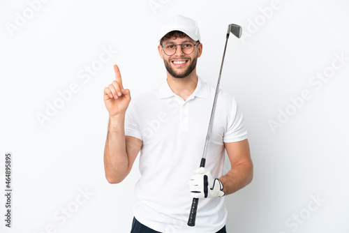 Handsome young man playing golf isolated on white background showing and lifting a finger in sign of the best