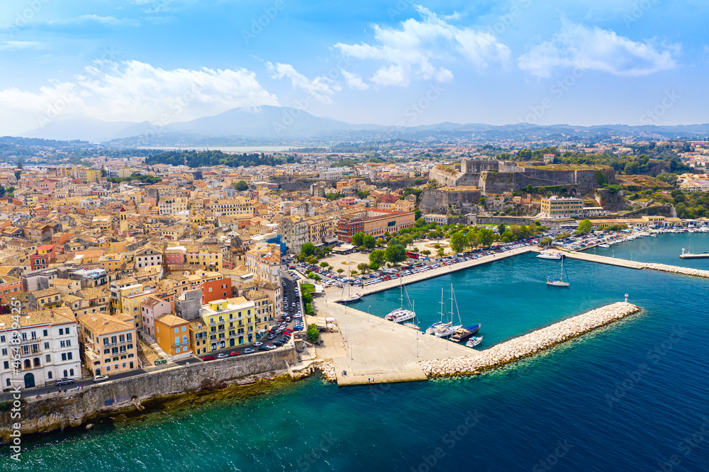 Aerial drone view of Kerkyra city with colorful houses during summer sunny day. Corfu island, Greece.