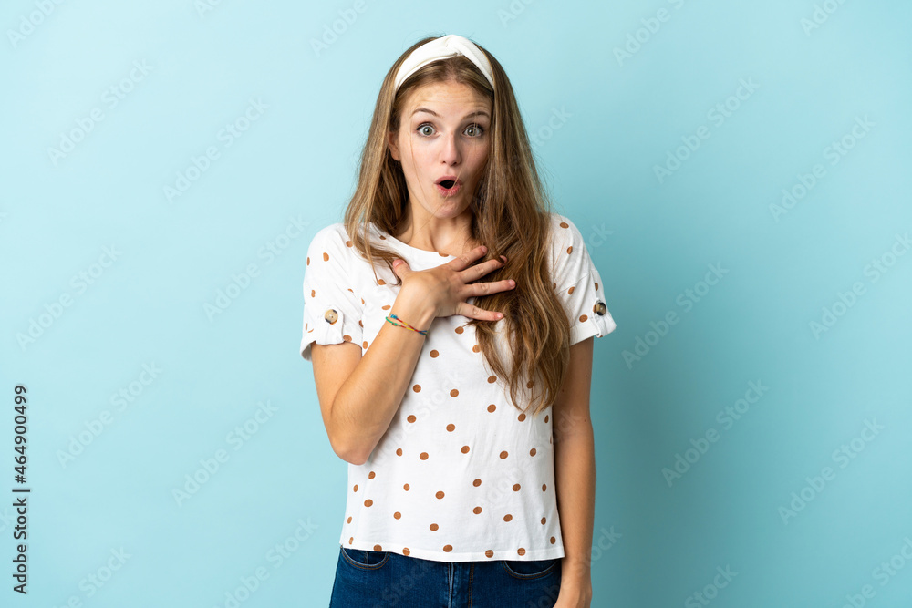 Young caucasian woman over isolated background surprised and shocked while looking right Young caucasian woman over isolated background surprised and shocked while looking right