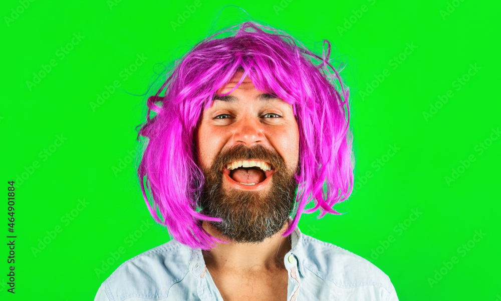 Smiling man in color wig Isolated on green background. Portrait of Bearded man with Colorfull hair.