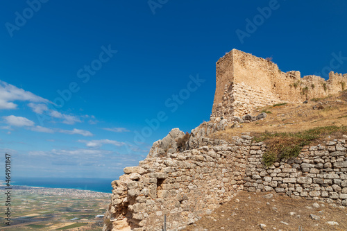Ruins of the ancient Greek city of Acrocorinth with stone walls, towers, and views of surroundings