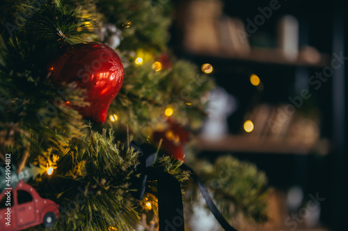 Close-up photo of Christmas decorations on the Christmas tree, multicolored red balls