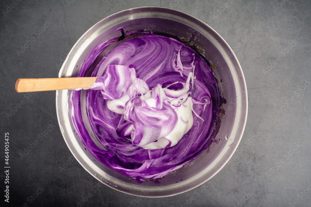 Mixing Meringue into Ube Cake Batter Using a spatula to mix up cake