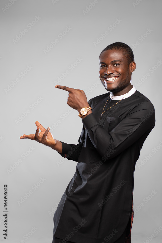 excited and happy young black man gestures to his side excited and happy young black man gestures to his side